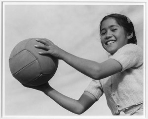 Girl and volley ball, Manzanar Relocation Center, California / photograph by Ansel Adams