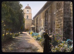 Friar in the garden courtyard, Mission Santa Barbara, 1917